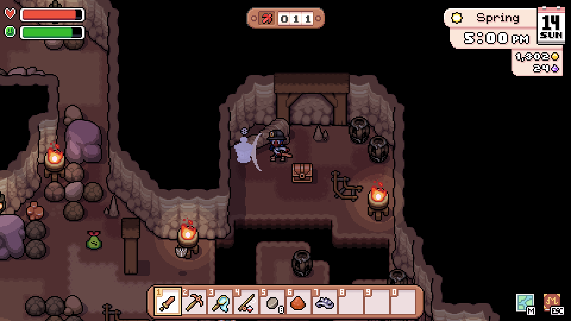 The player fighting a monster in the Mines beside a treasure chest in Fields of Mistria.
